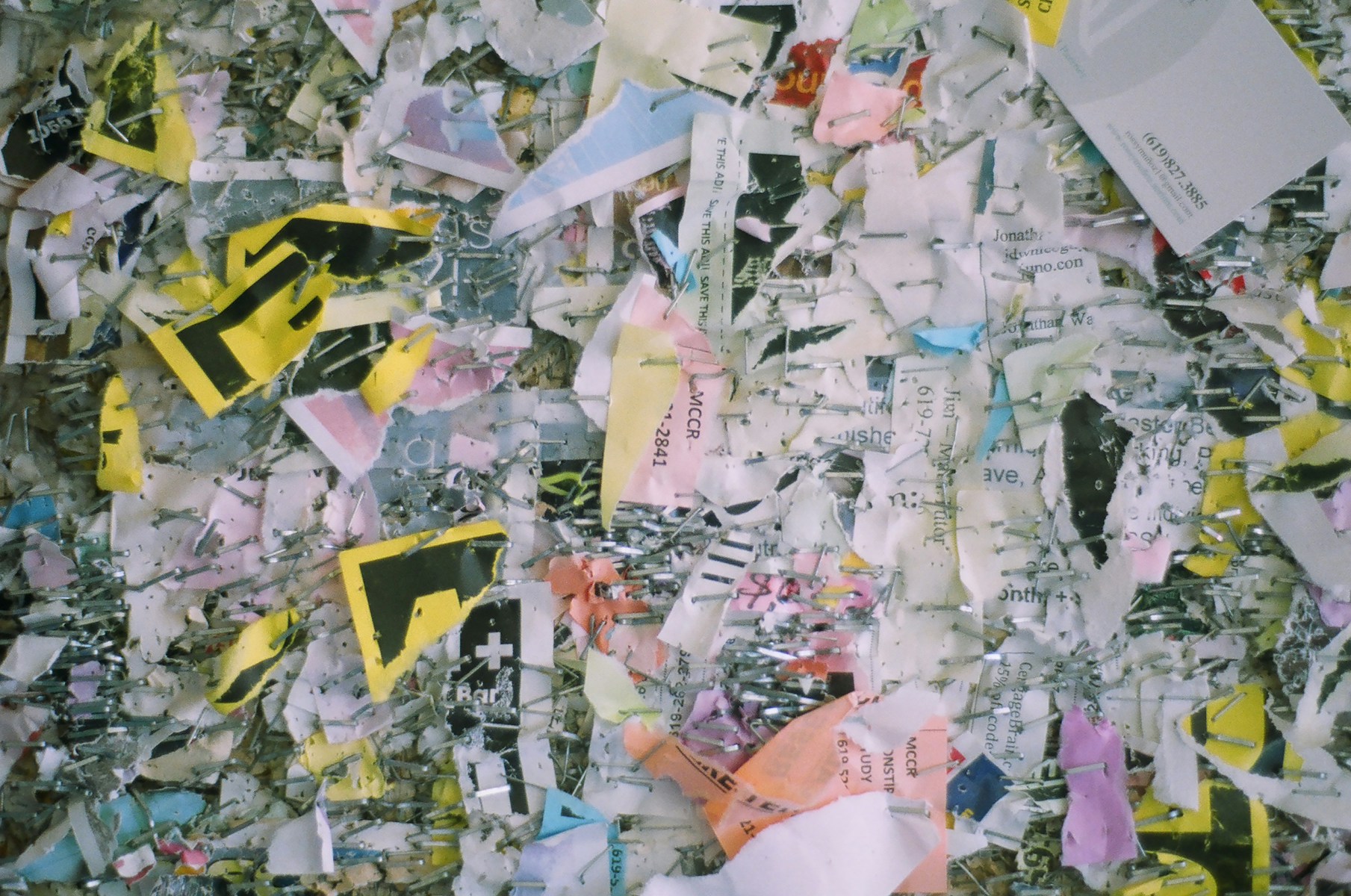 a wall covered in lots of different colored pieces of paper